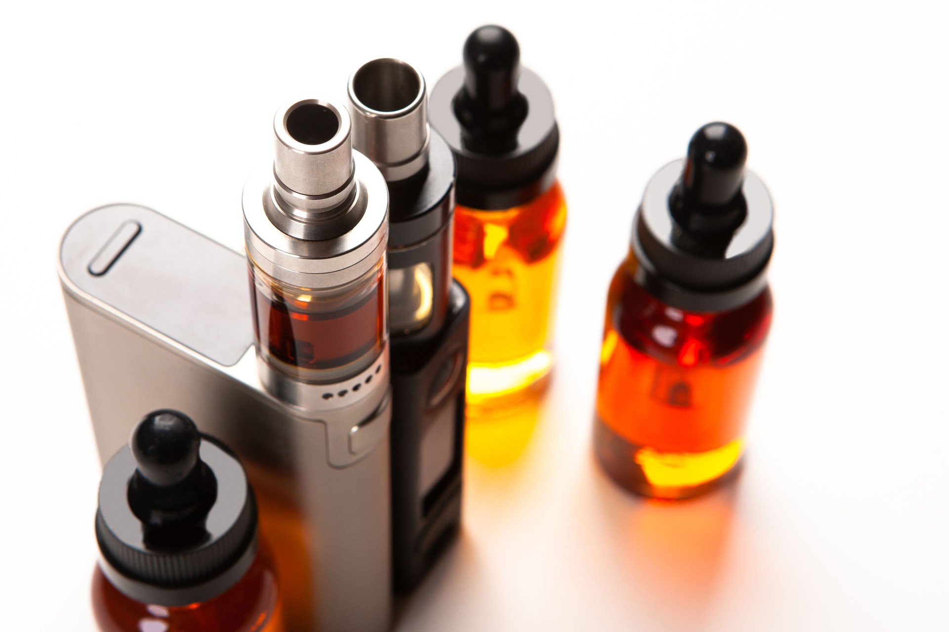 The view from the top to the vapes and liquids. In a VAPE shop. Demonstration of gadgets for Smoking. Vaping. Electronic devices for vaping. Electronic cigarettes of different models. E-cigarettes.